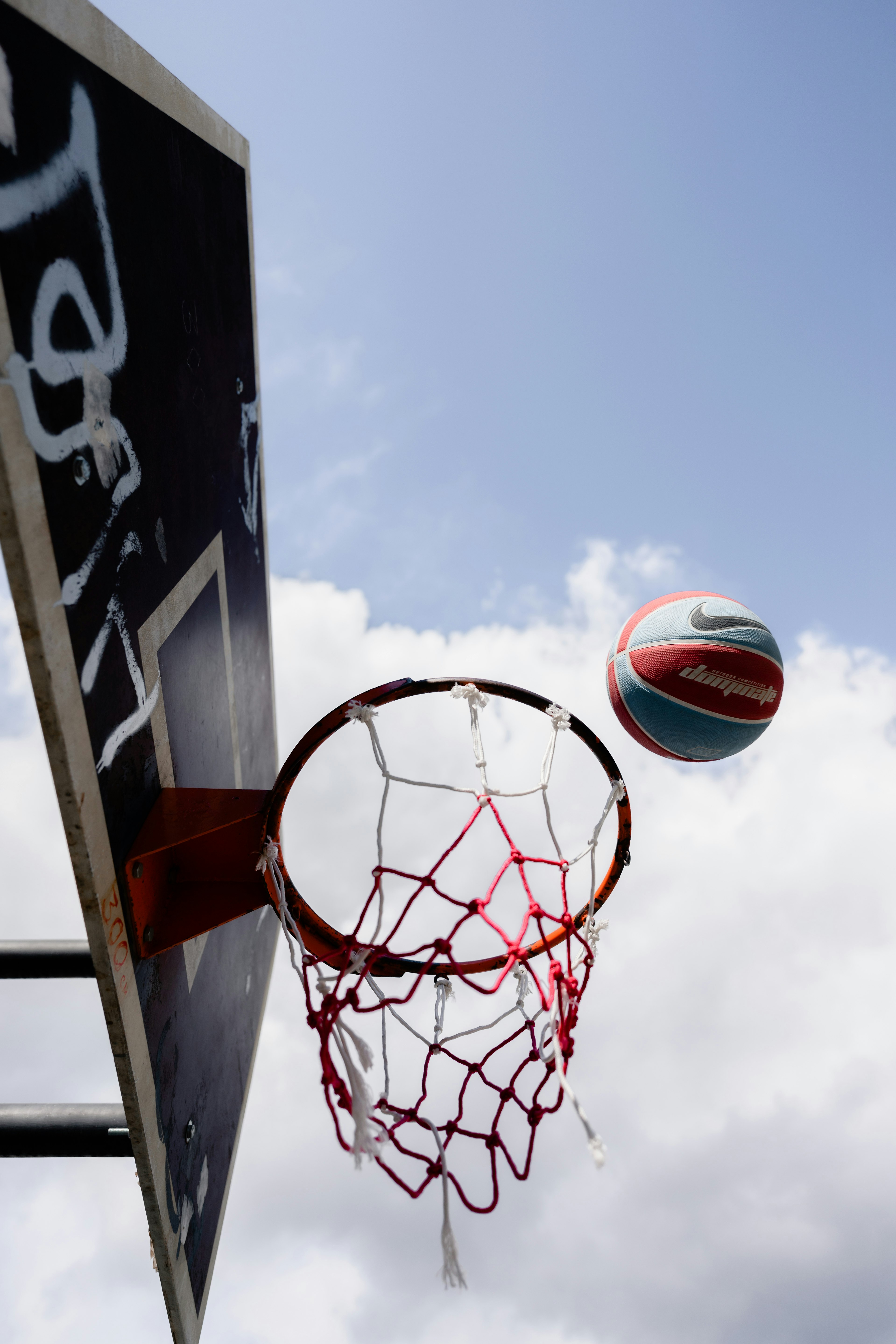 white and red basketball hoop under blue sky during daytime